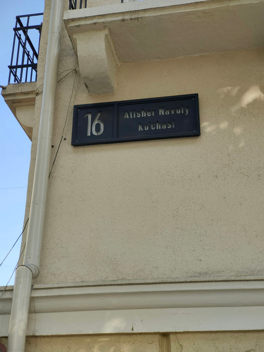 a black and white sign on the side of a building